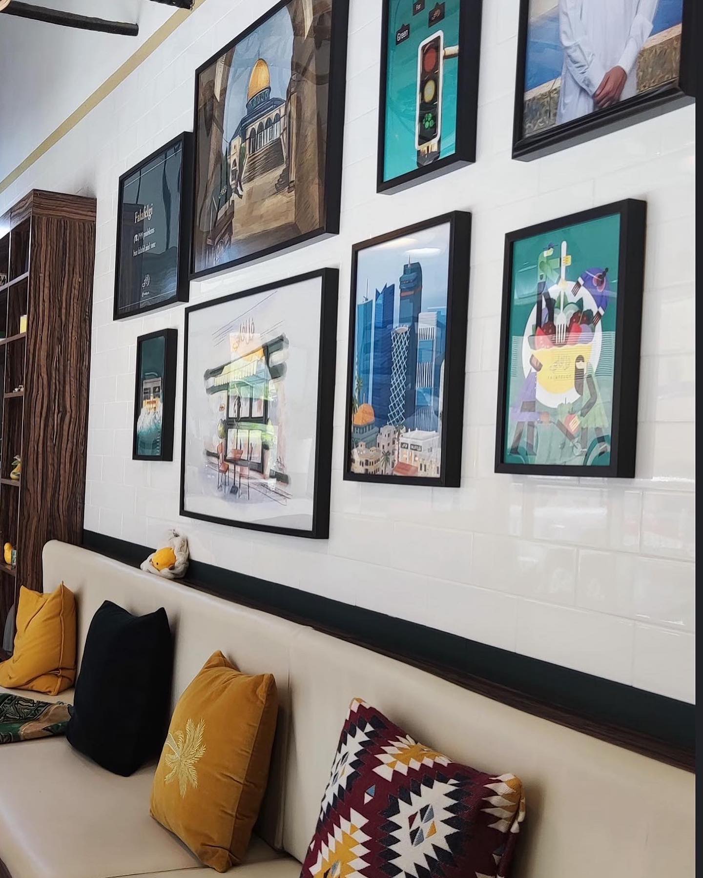FalafelGi restaurant interior with the illustrated poster framed on the wall
