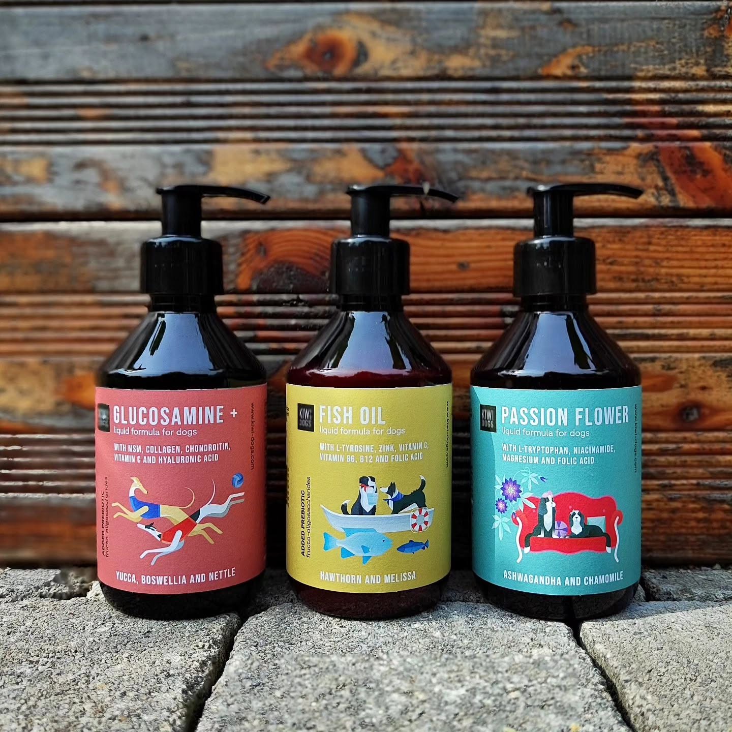 Three finished Kiwi Dogs supplement bottles with illustrated coral, yellow and turquoise labels.